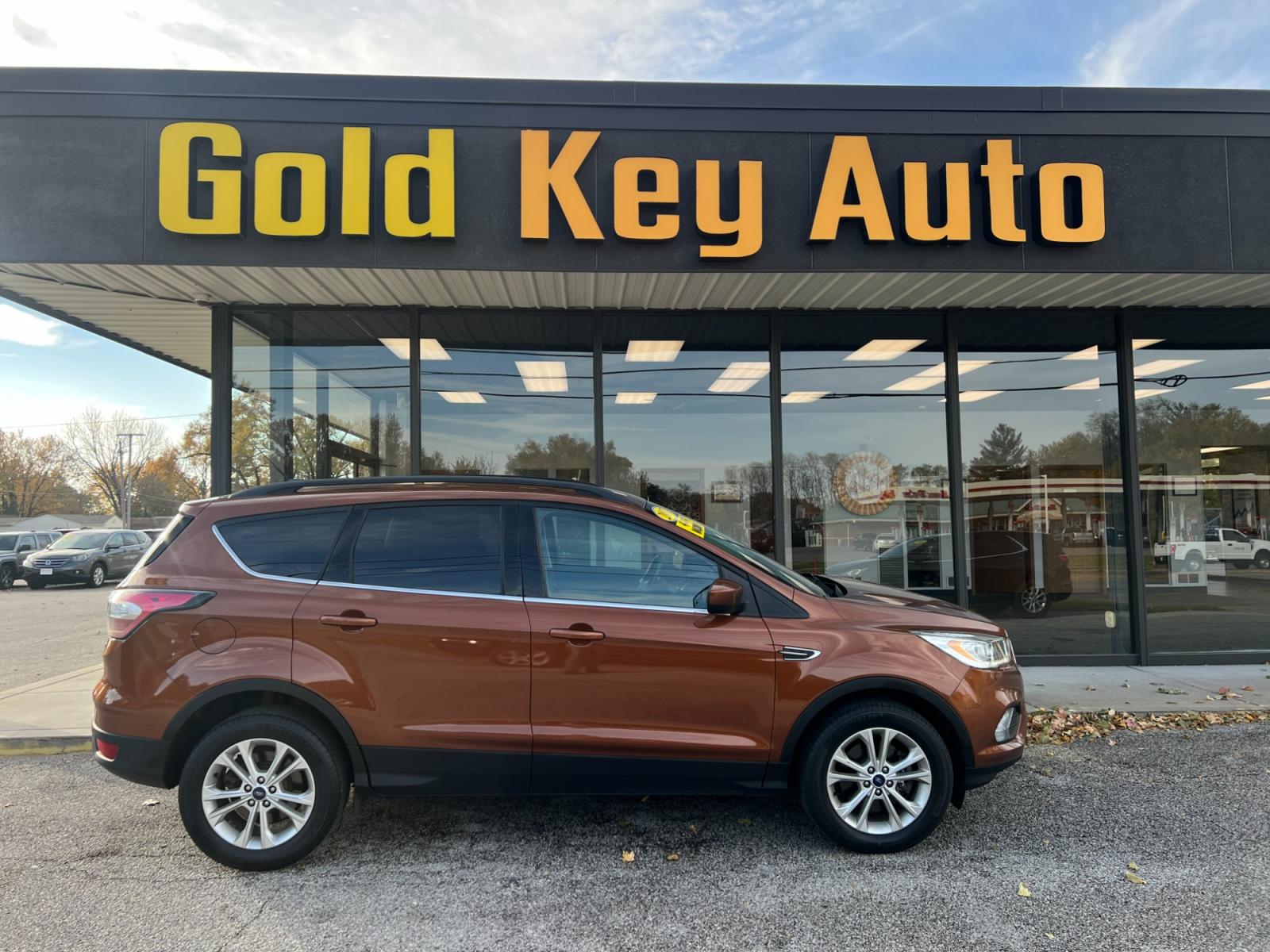 2017 Bronze Ford Escape SE 4WD (1FMCU9GDXHU) with an 1.5L L4 DOHC 16V engine, 6A transmission, located at 1633 W Kimberly, Davenport, 52806, (563) 323-5341, 41.559456, -90.598732 - Photo #0