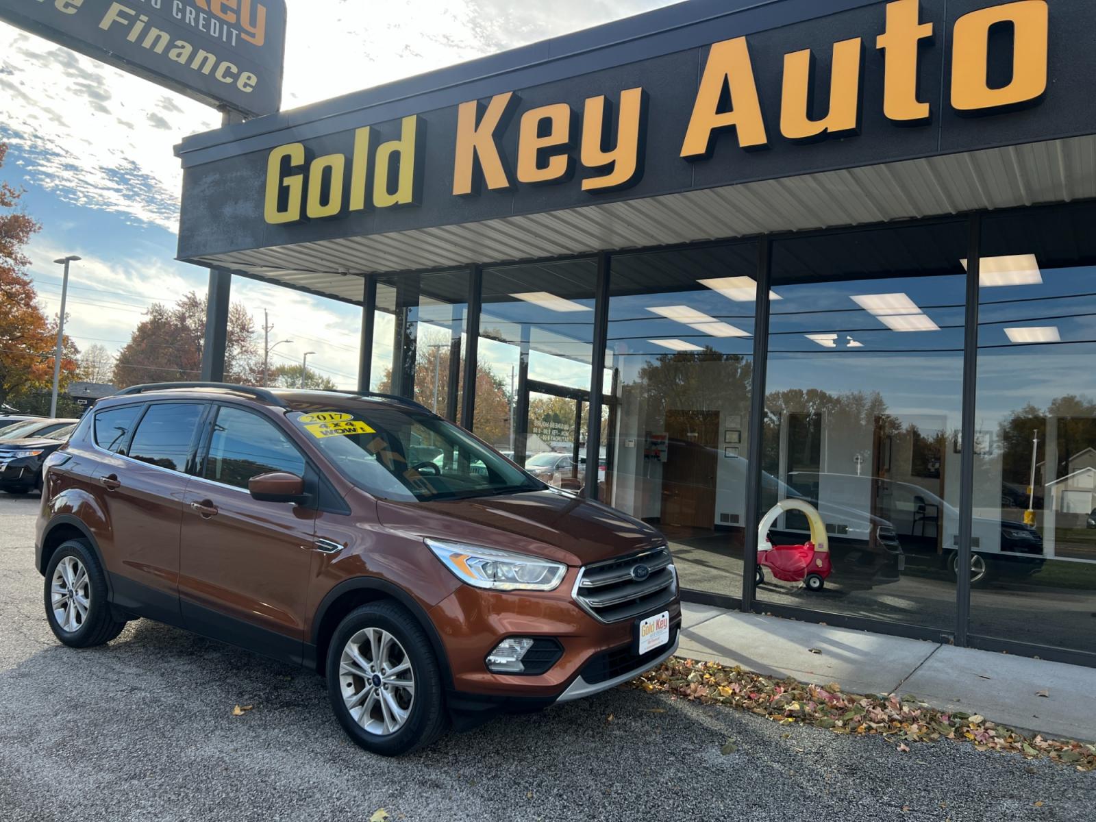 2017 Bronze Ford Escape SE 4WD (1FMCU9GDXHU) with an 1.5L L4 DOHC 16V engine, 6A transmission, located at 1633 W Kimberly, Davenport, 52806, (563) 323-5341, 41.559456, -90.598732 - Photo #1