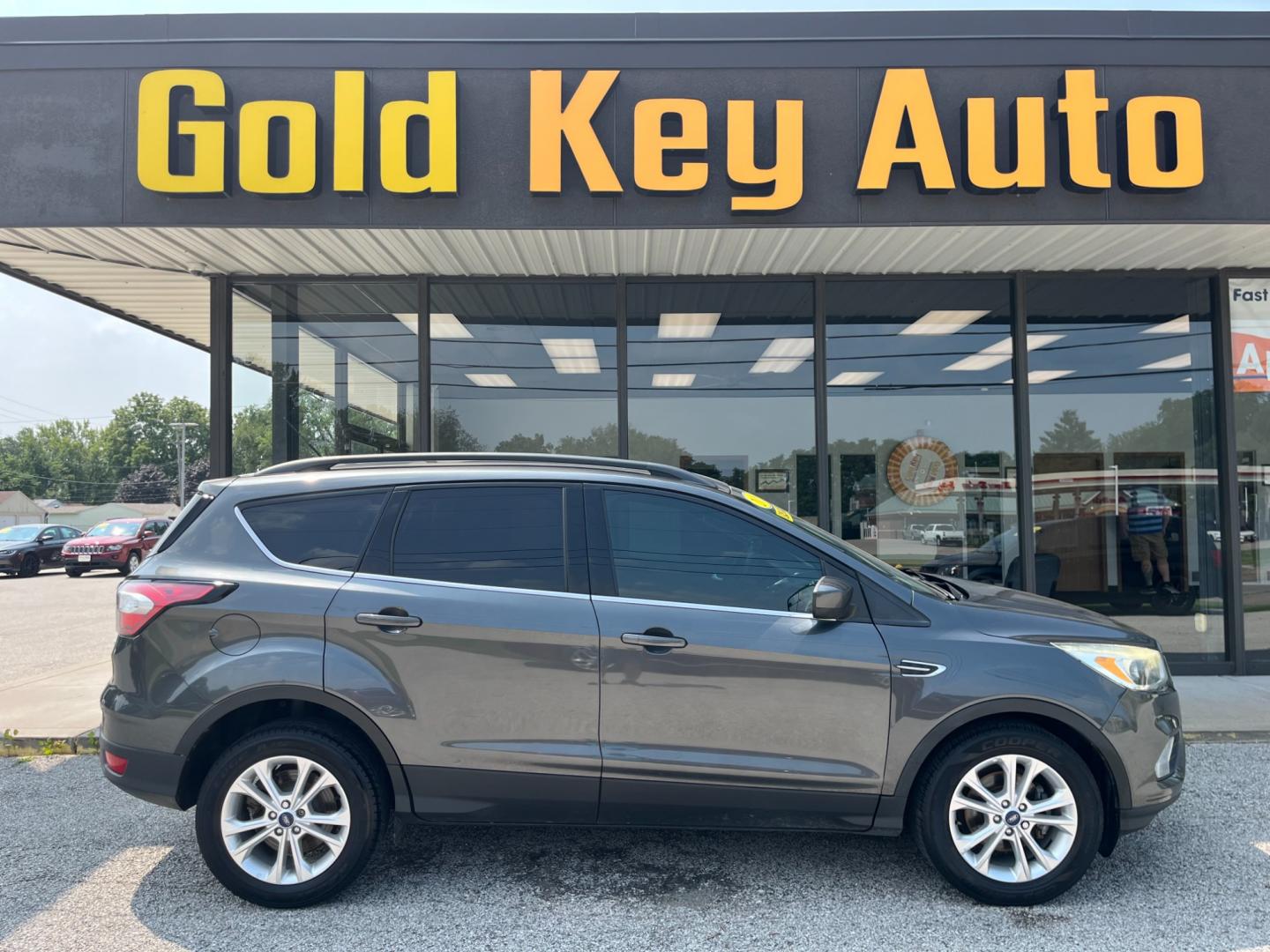 2018 Magnetic Metallic Ford Escape SE FWD (1FMCU0GD3JU) with an 1.5L L4 DOHC 16V engine, 6-Speed Automatic transmission, located at 1633 W Kimberly, Davenport, IA, 52806, (563) 323-5341, 41.559456, -90.598732 - Photo#0